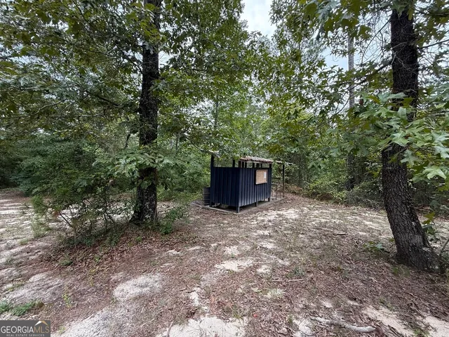 a backyard of a house with wooden deck and backyard