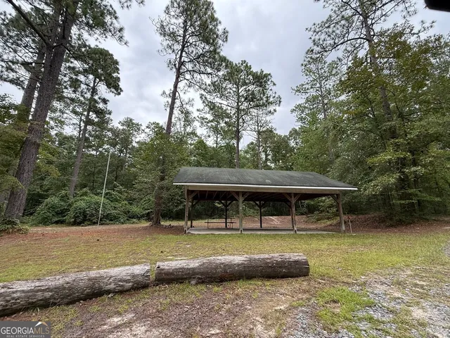 a view of a house with a yard and sitting area