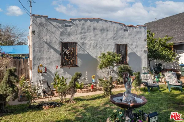 a backyard of a house with outdoor seating