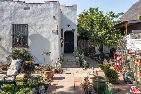 a view of a patio with table and chairs potted plants