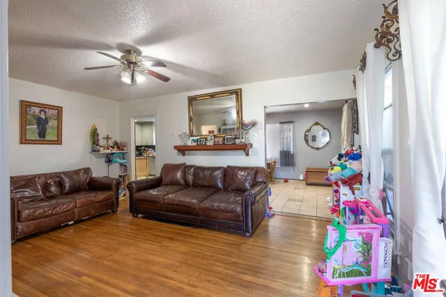 a living room with furniture and painting on the wall