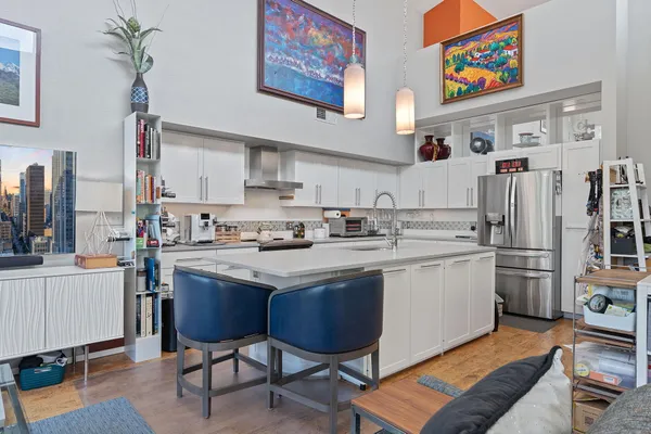 a kitchen with stainless steel appliances a sink and a refrigerator