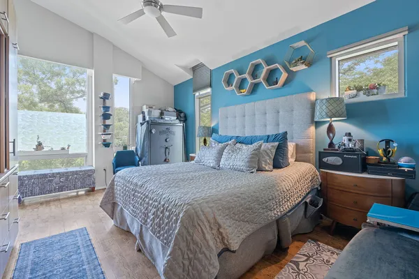a bedroom with a bed and a chandelier