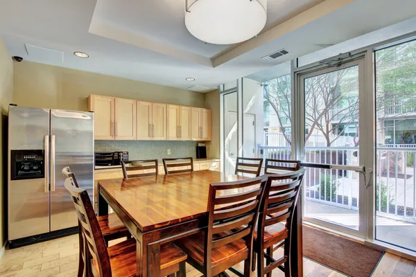 a dining room with furniture and wooden floor