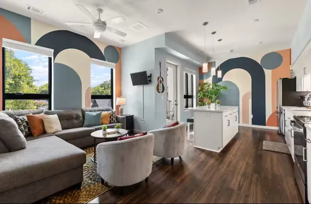 a living room with furniture and wooden floor