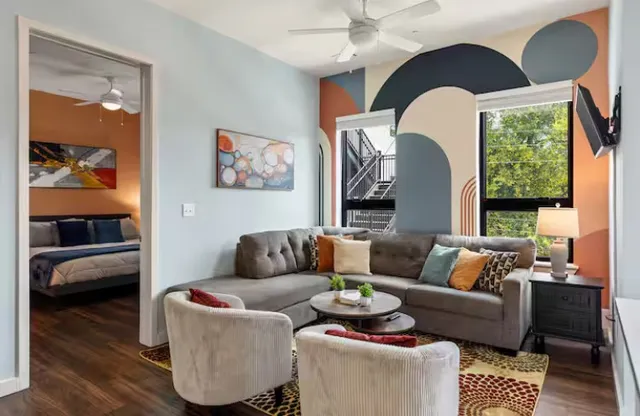 a living room with furniture and a wooden floor