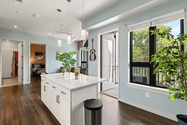 a bed room with a bed and painting on the wall