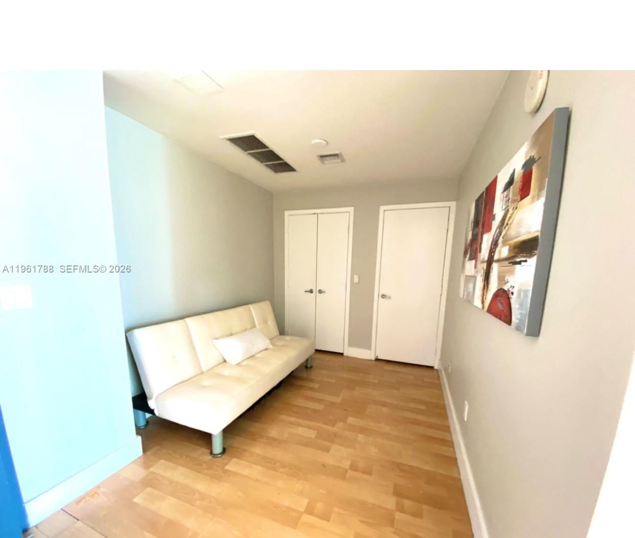 888 Biscayne Boulevard, Unit 1603 Miami, FL 33132 - Photo 10 of 14 a bedroom with a bed and a painting on the wall