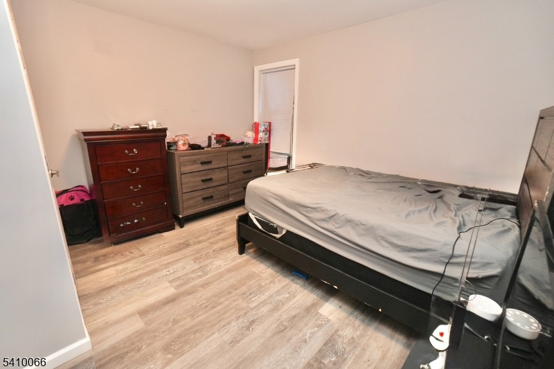 172 Delavan Avenue Newark, NJ 07104 - Photo 14 of 16 a bedroom with a bed and a mirror