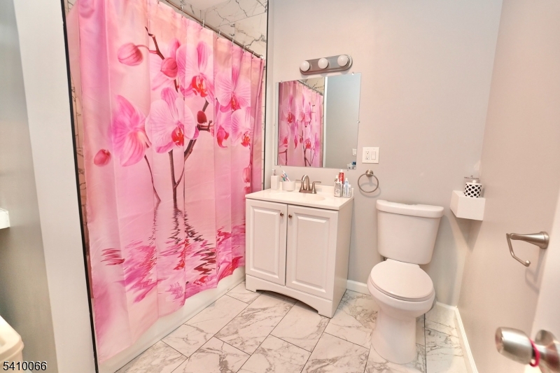 172 Delavan Avenue Newark, NJ 07104 - Photo 15 of 16 a bathroom with a sink toilet and shower
