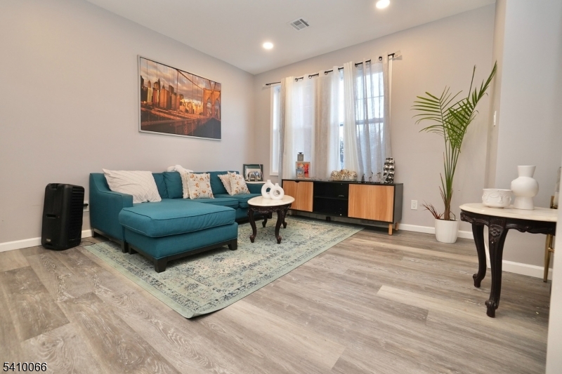 172 Delavan Avenue Newark, NJ 07104 - Photo 2 of 16 a living room with furniture and a potted plant