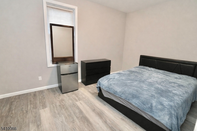 172 Delavan Avenue Newark, NJ 07104 - Photo 7 of 16 a bedroom with a bed and a table