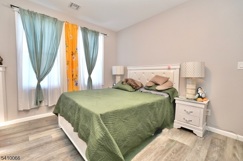 172 Delavan Avenue Newark, NJ 07104 - Photo 9 of 16 a bedroom with a bed and wooden floor