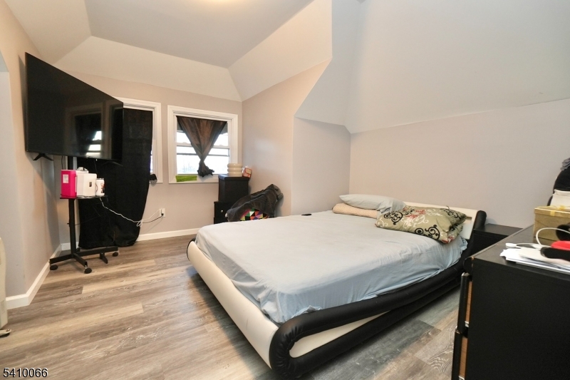 172 Delavan Avenue Newark, NJ 07104 - Photo 10 of 16 a bed sitting in a bedroom and a flat screen tv