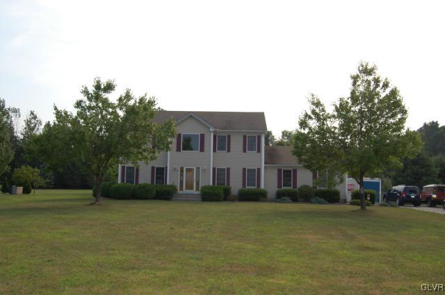 1261 Miller Road Wind Gap, PA 18091 - Photo 23 of 24 a front view of a house with a garden and trees