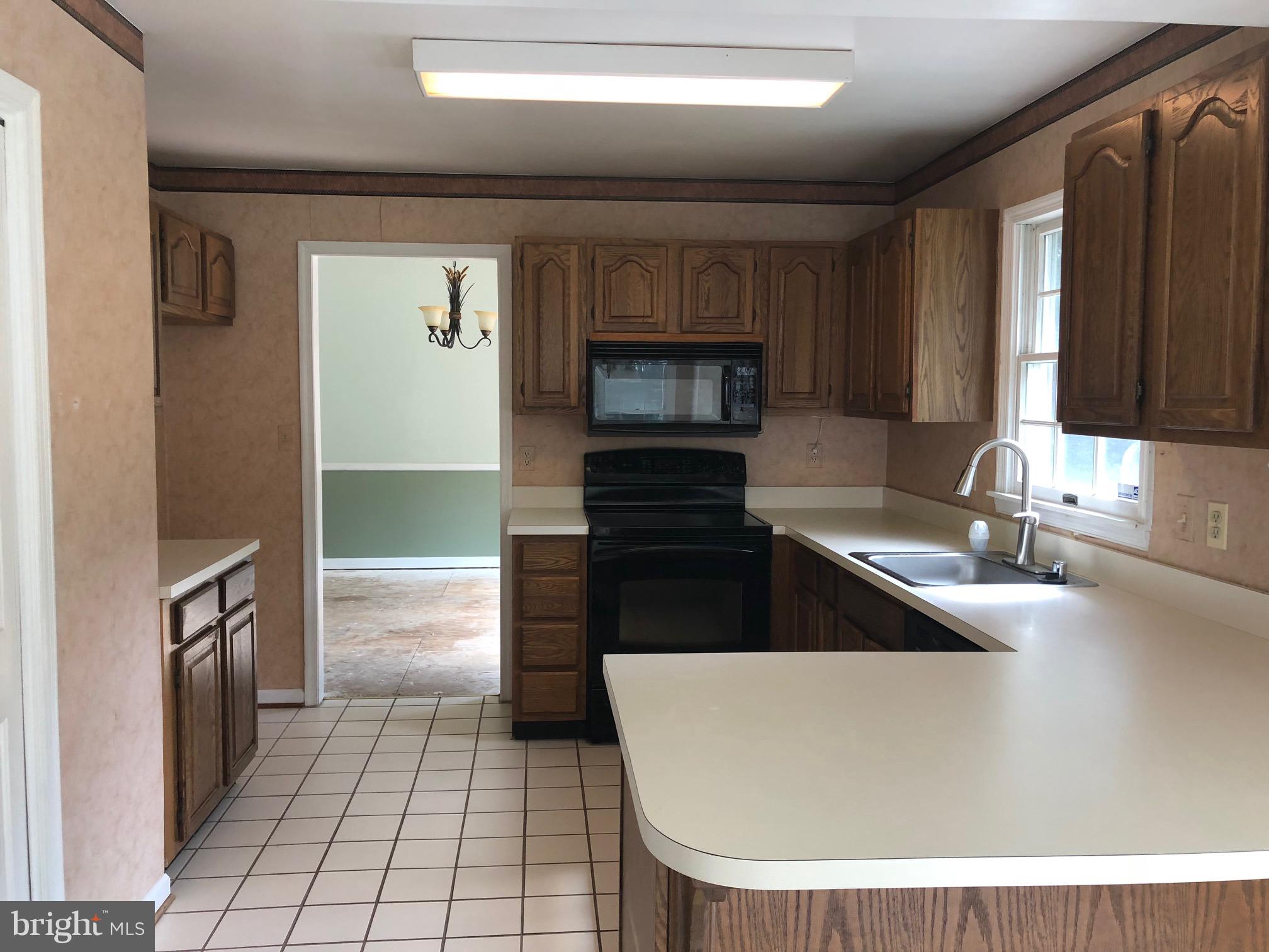 4333 Sweet Air Road Baldwin, MD 21013 - Photo 5 of 28 a kitchen with a refrigerator and a sink