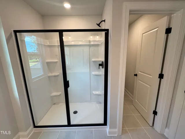 a bathroom with a glass shower door
