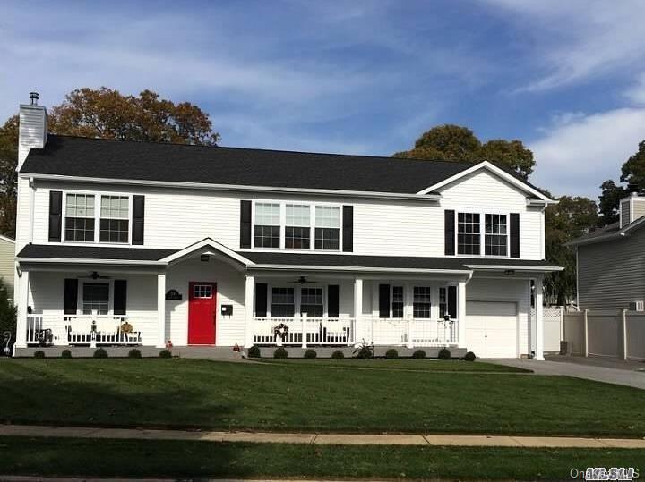 34 Cliff Road Merrick, NY 11566 - Photo 1 of 1 a front view of a house with a garden