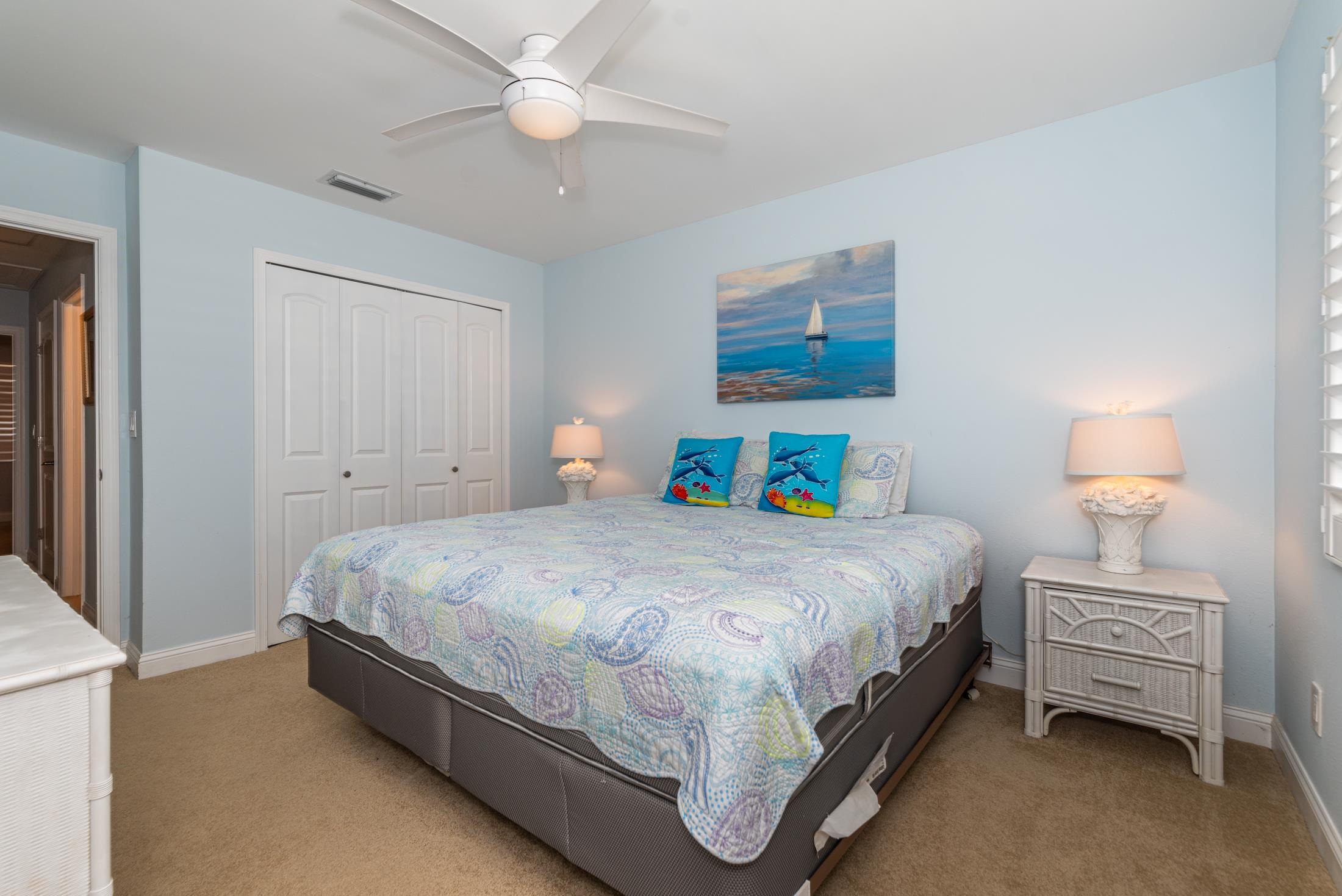 126 Rio Del Mar Street, Unit B St. Augustine, FL 32080 - Photo 12 of 24 a bedroom with a bed and a lamp on the dresser