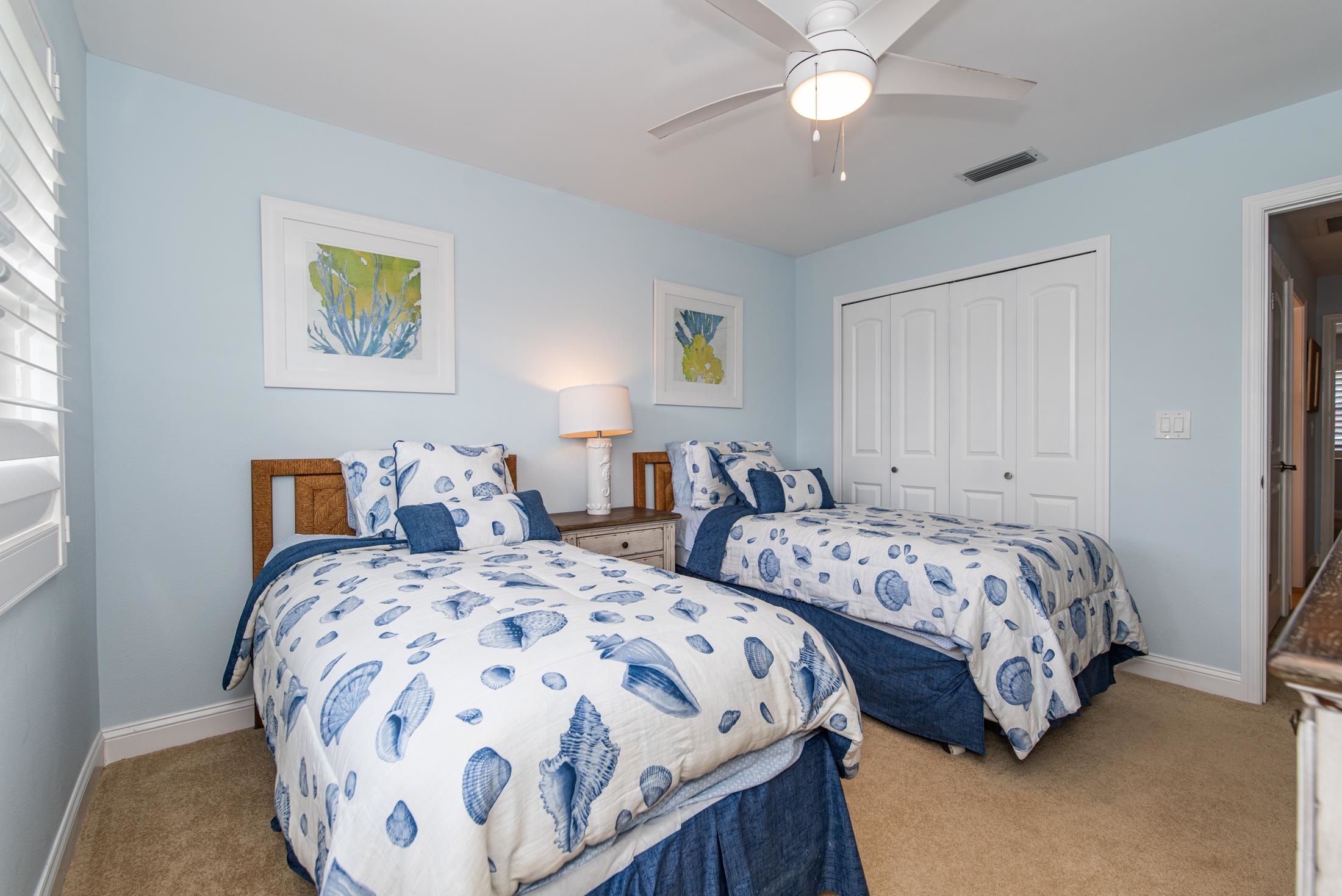 126 Rio Del Mar Street, Unit B St. Augustine, FL 32080 - Photo 16 of 24 a bedroom with two beds and a chandelier