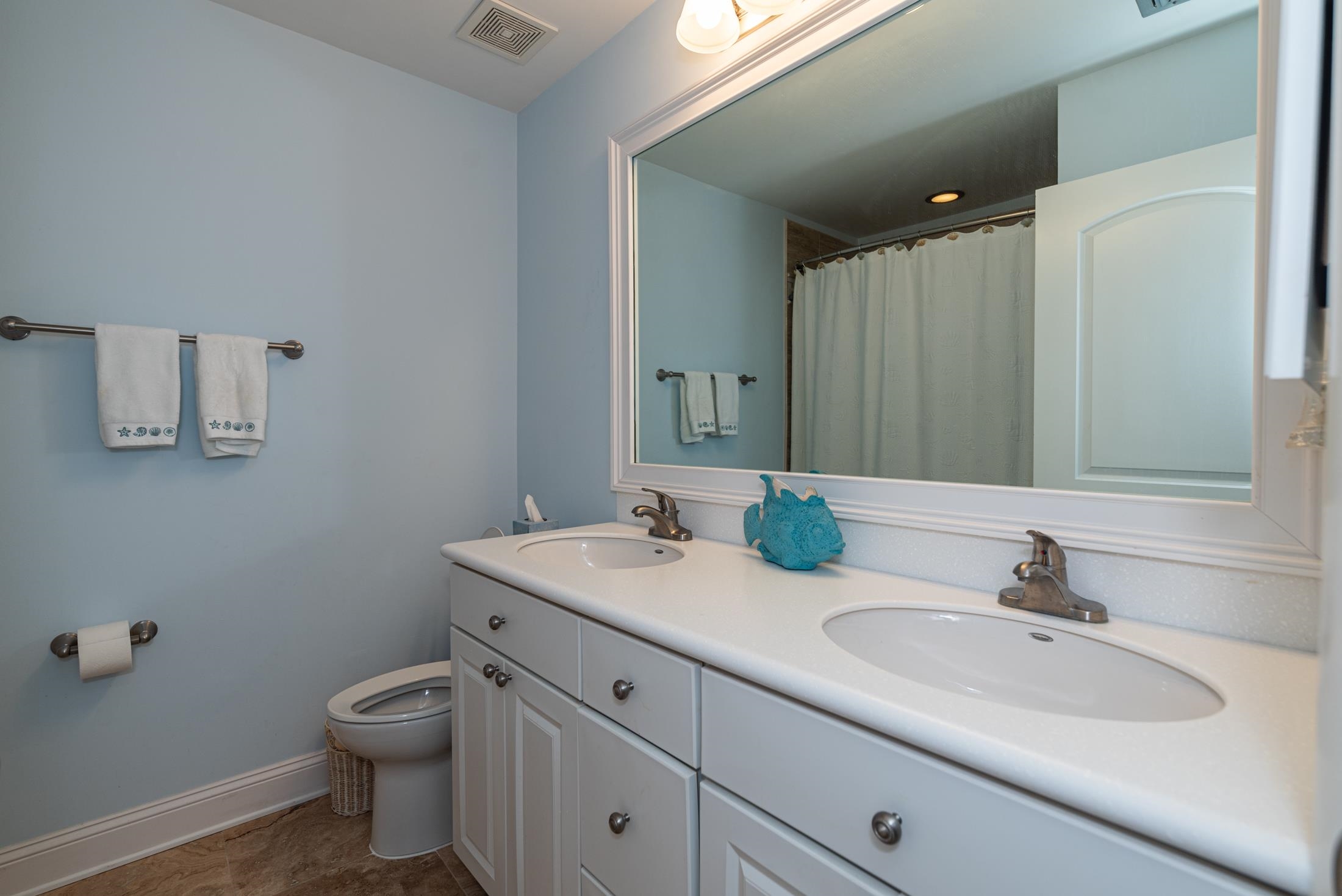126 Rio Del Mar Street, Unit B St. Augustine, FL 32080 - Photo 17 of 24 a bathroom with a sink toilet and mirror