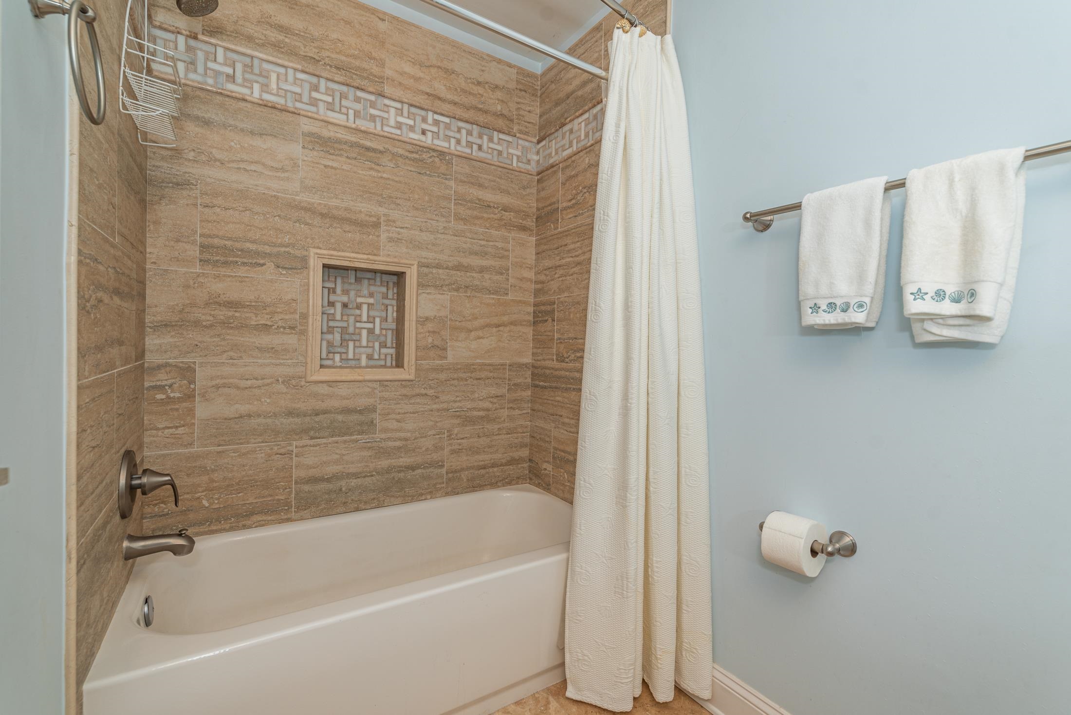 126 Rio Del Mar Street, Unit B St. Augustine, FL 32080 - Photo 18 of 24 a bathroom with a tub and shower