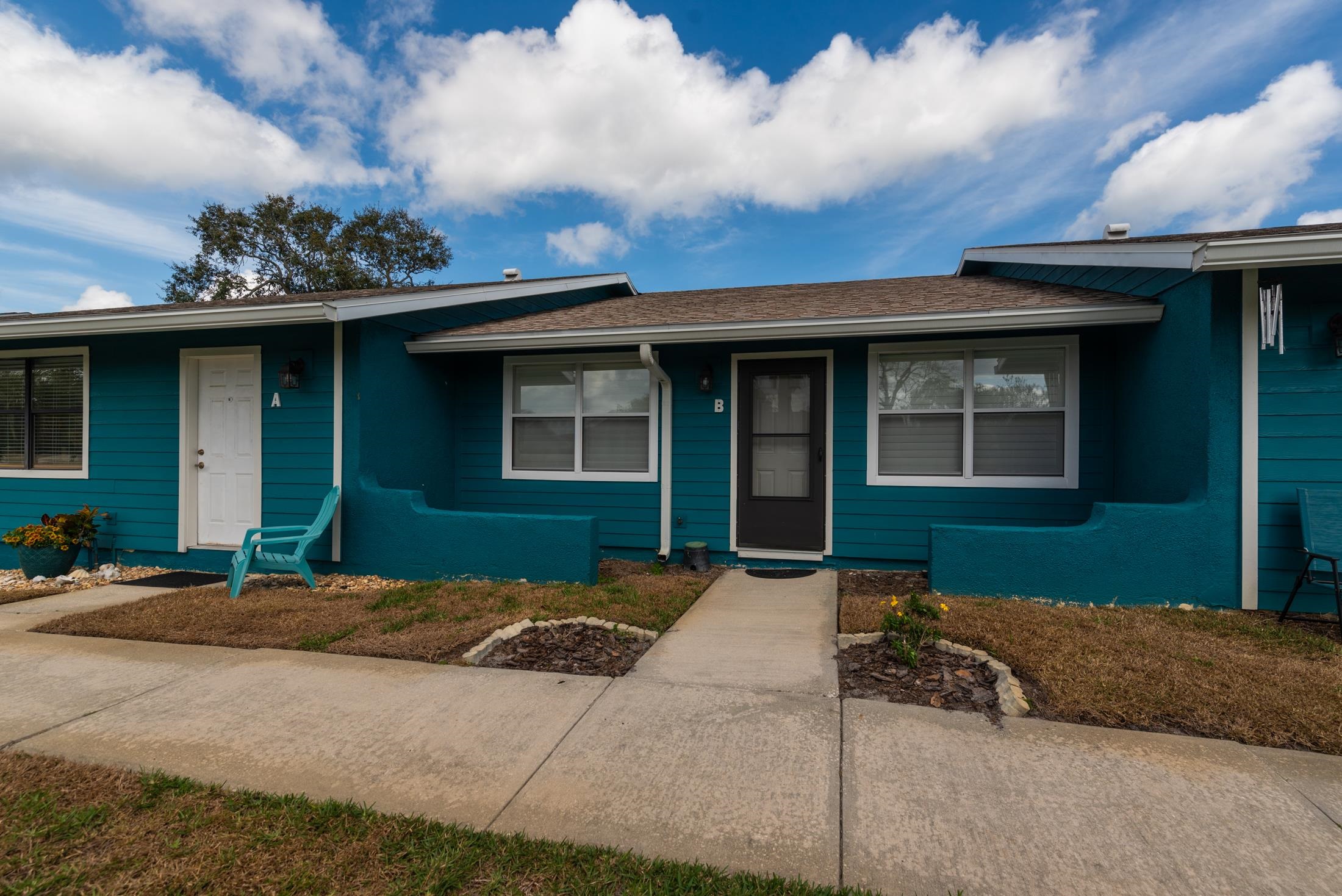 126 Rio Del Mar Street, Unit B St. Augustine, FL 32080 - Photo 2 of 24 a front view of a house with a yard