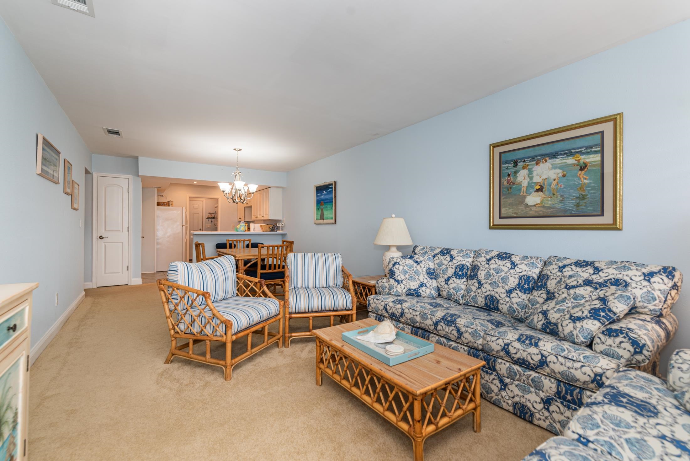 126 Rio Del Mar Street, Unit B St. Augustine, FL 32080 - Photo 3 of 24 a living room with furniture and a wall painting