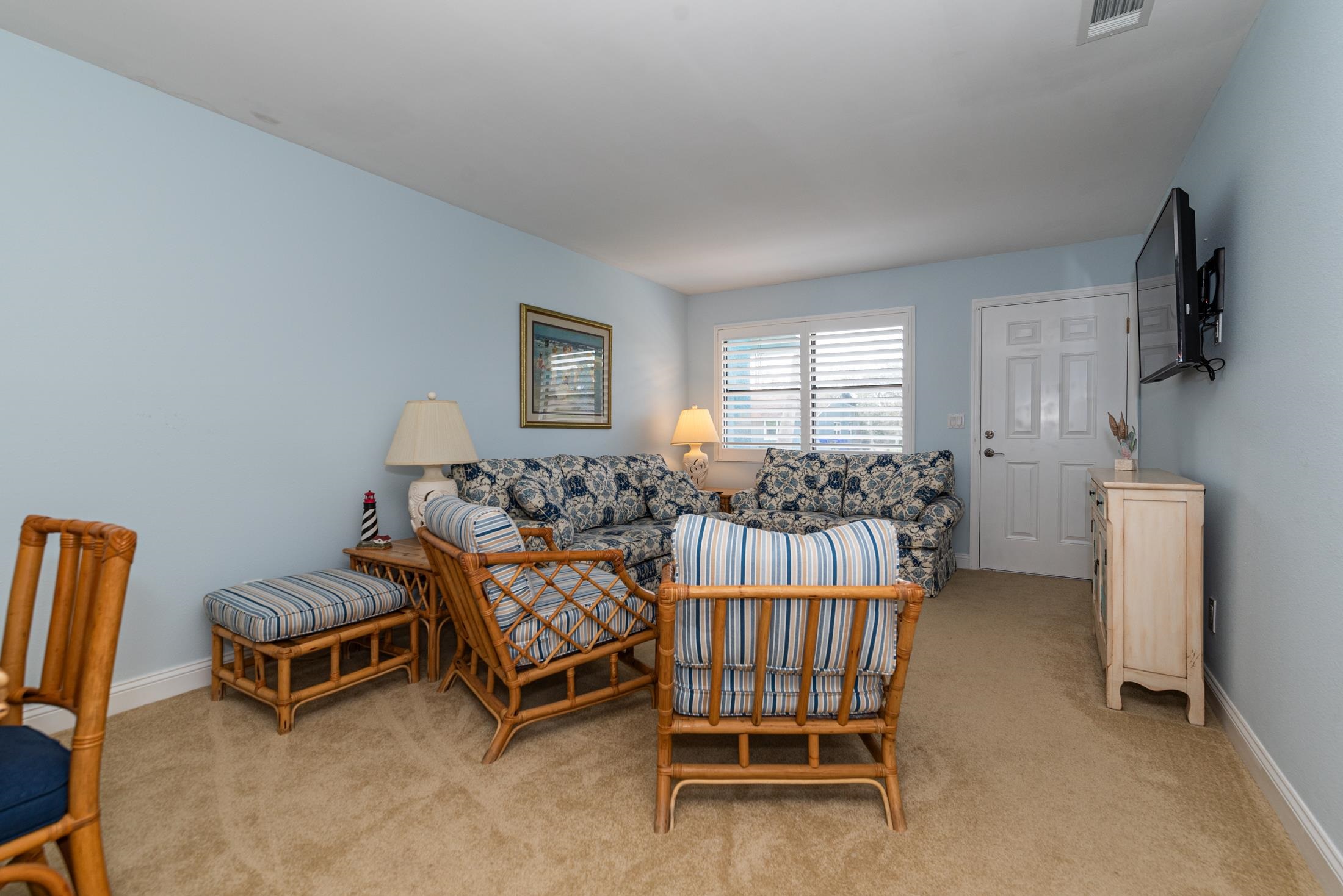 126 Rio Del Mar Street, Unit B St. Augustine, FL 32080 - Photo 4 of 24 a bedroom with furniture and a flat screen tv