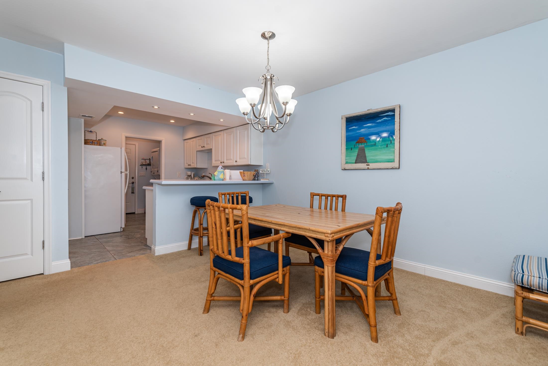 126 Rio Del Mar Street, Unit B St. Augustine, FL 32080 - Photo 6 of 24 a dining room with furniture and chandelier