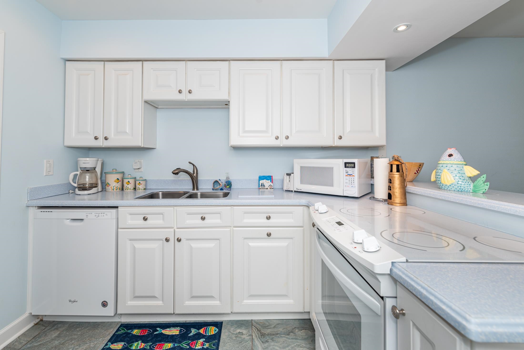 126 Rio Del Mar Street, Unit B St. Augustine, FL 32080 - Photo 8 of 24 a kitchen with granite countertop white cabinets and sink