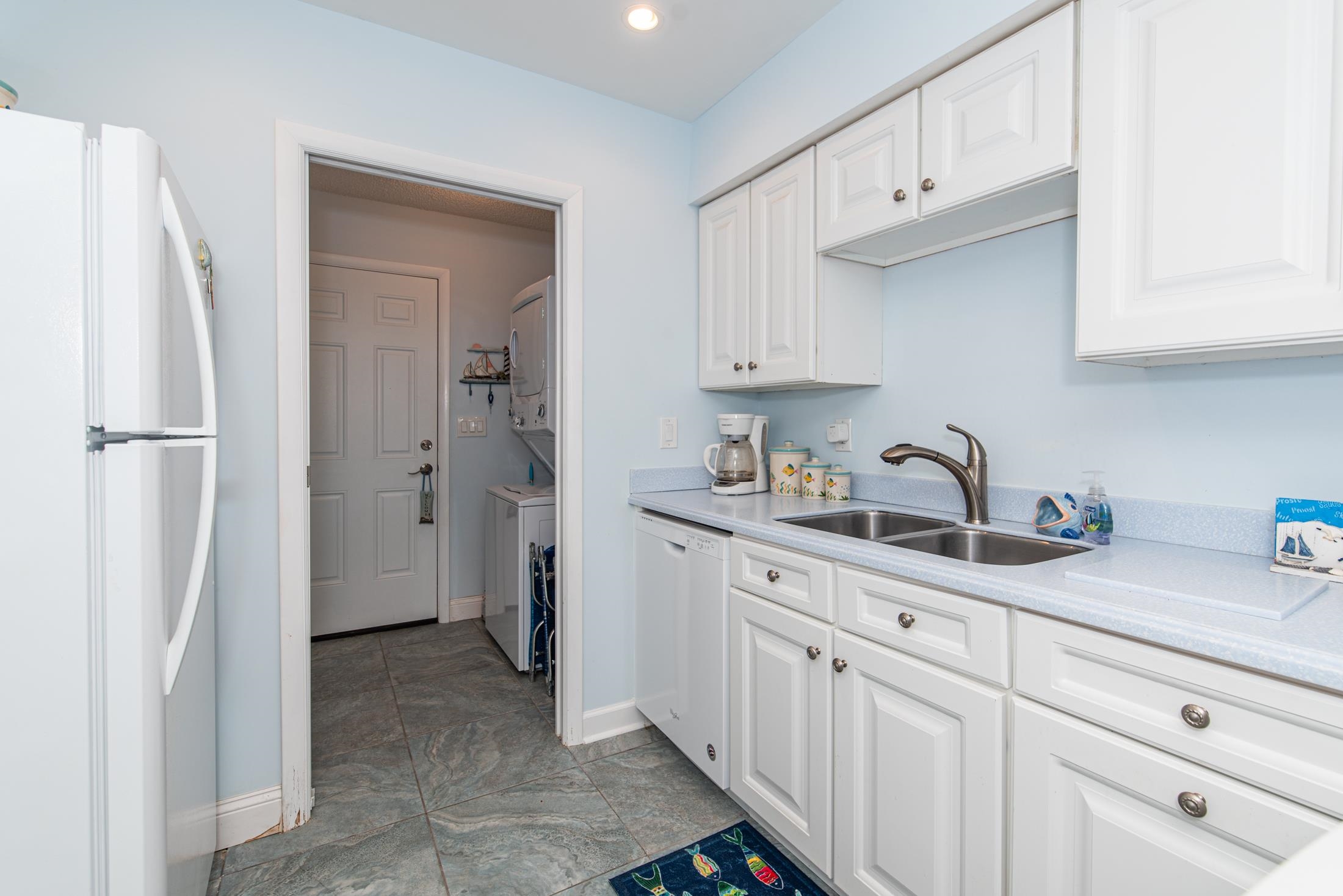 126 Rio Del Mar Street, Unit B St. Augustine, FL 32080 - Photo 9 of 24 a kitchen with stainless steel appliances a sink and cabinets