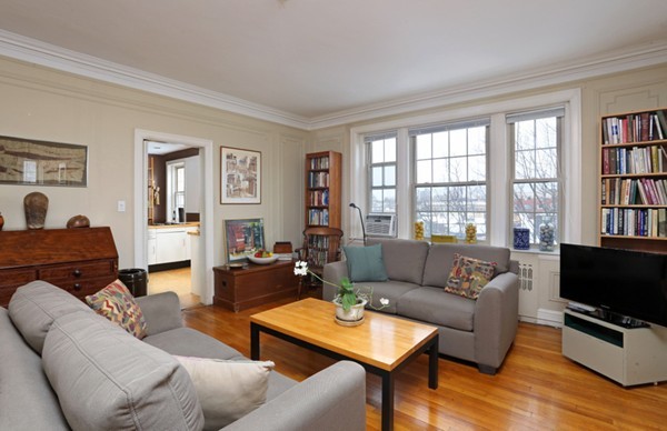 1258 Beacon Street, Unit 7 Brookline, MA 02446 - Photo 2 of 6 a living room with furniture a flat screen tv and a window