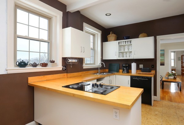 1258 Beacon Street, Unit 7 Brookline, MA 02446 - Photo 4 of 6 a kitchen with stainless steel appliances granite countertop a sink and a stove