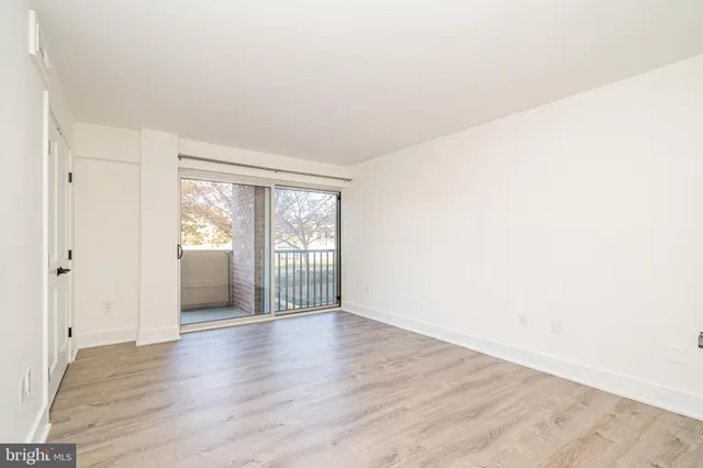 a view of wooden floor and windows in a room