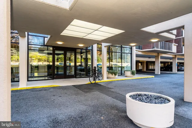 a view of an empty room with wooden floor and a fireplace