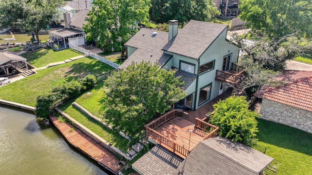 an aerial view of a house with swimming pool and outdoor seating
