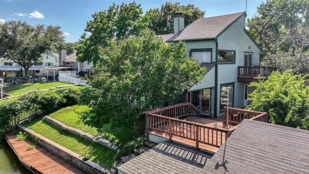 696 Harbor Drive North Azle, TX 76020 - Photo 2 of 40 a view of a chairs setting on the deck in front of house