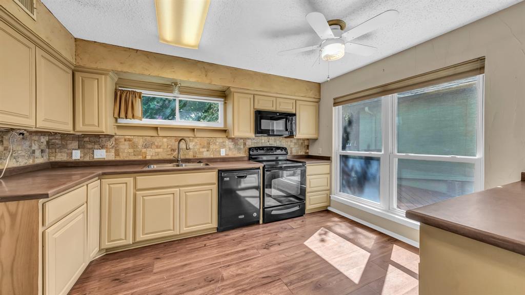 696 Harbor Drive North Azle, TX 76020 - Photo 25 of 40 a kitchen with stainless steel appliances granite countertop a stove and a sink