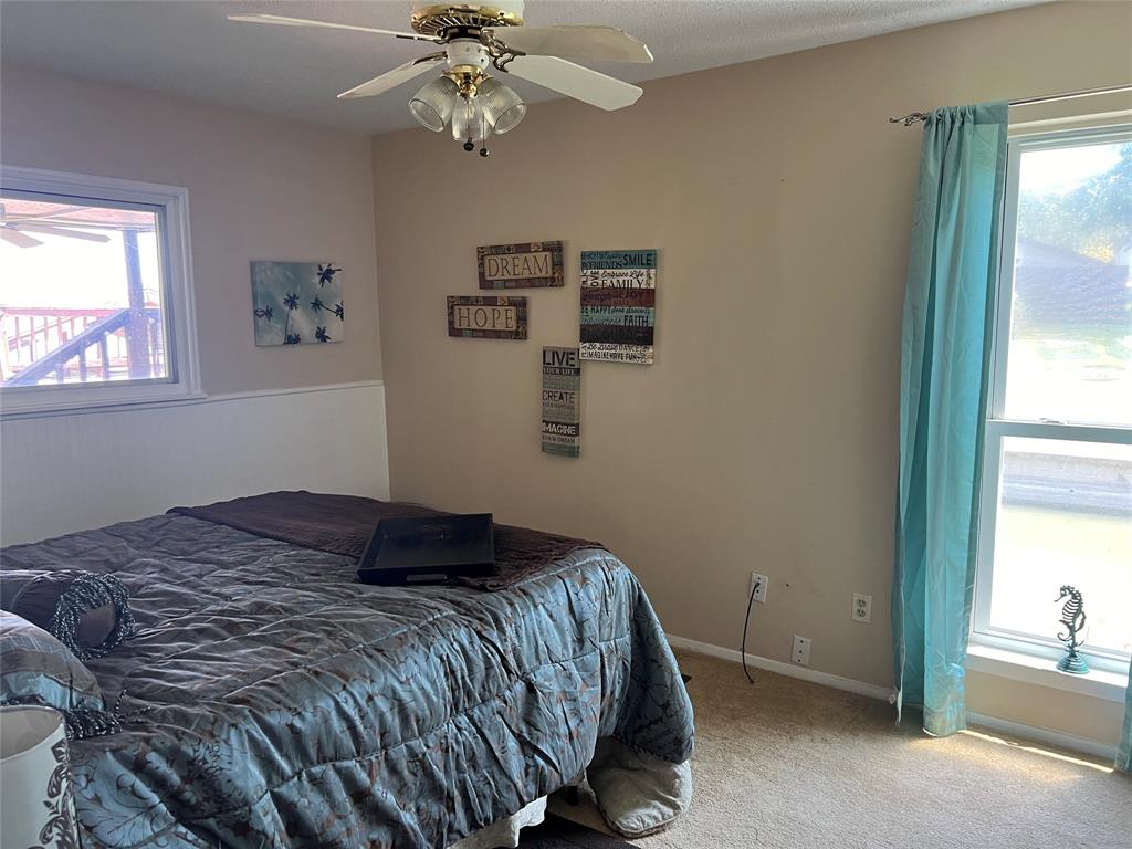 696 Harbor Drive North Azle, TX 76020 - Photo 27 of 40 a bedroom with a bed and a chandelier