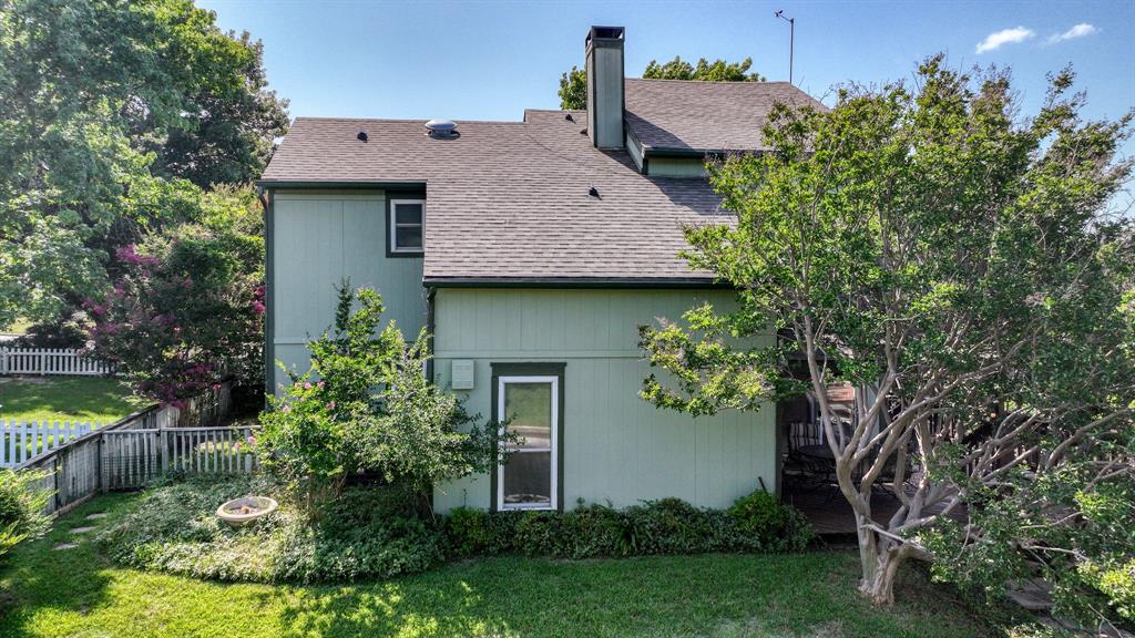 696 Harbor Drive North Azle, TX 76020 - Photo 3 of 40 a aerial view of a house with table and chairs potted plants and large tree