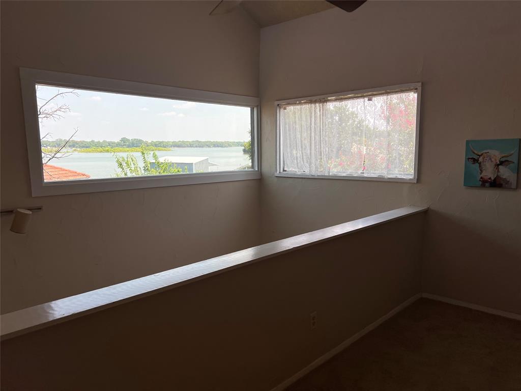 696 Harbor Drive North Azle, TX 76020 - Photo 32 of 40 a view of an empty room with wooden floor and a window