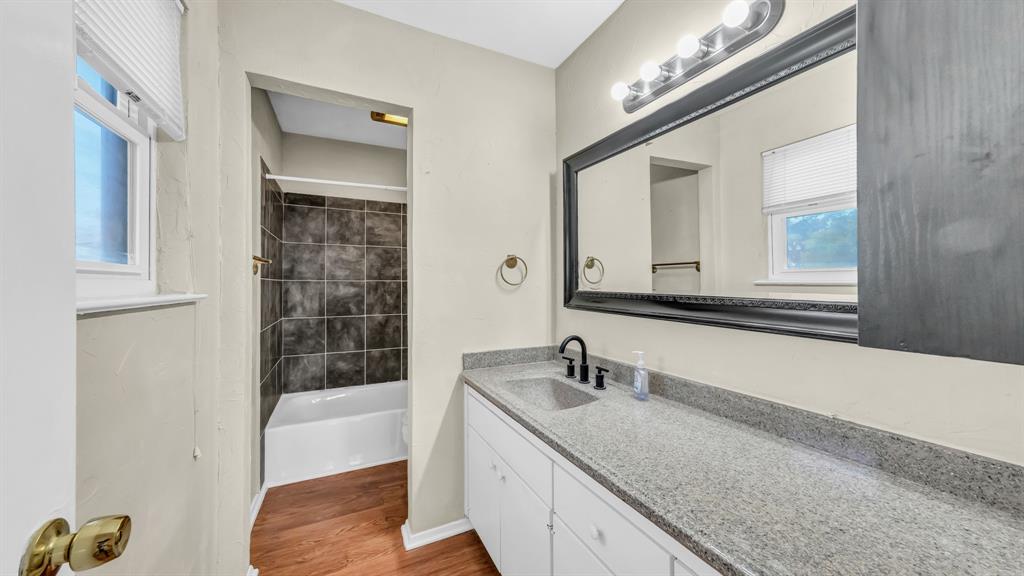696 Harbor Drive North Azle, TX 76020 - Photo 39 of 40 a bathroom with a granite countertop double vanity sink and mirror