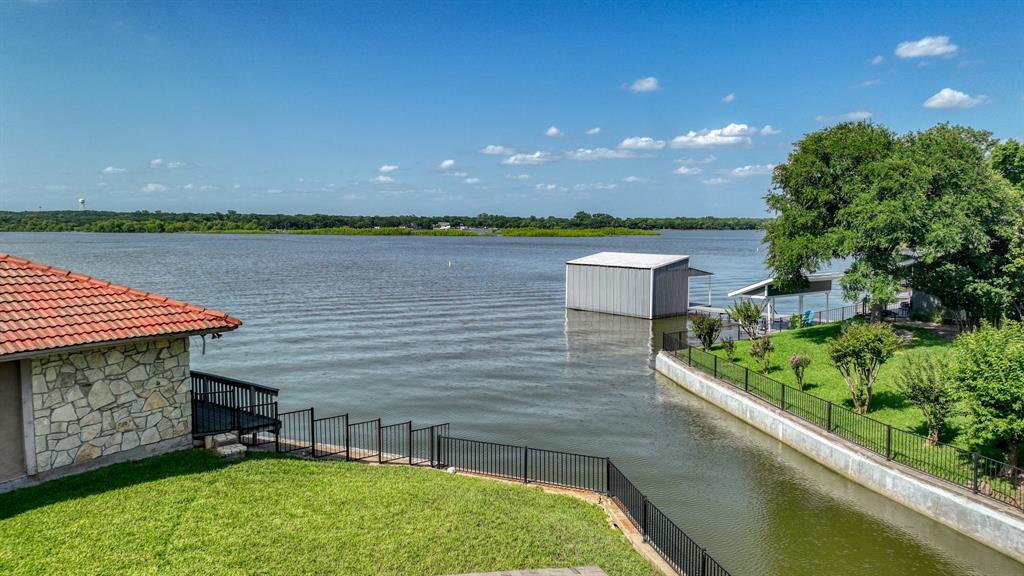 696 Harbor Drive North Azle, TX 76020 - Photo 7 of 40 a view of a back yard of the house with a lake view