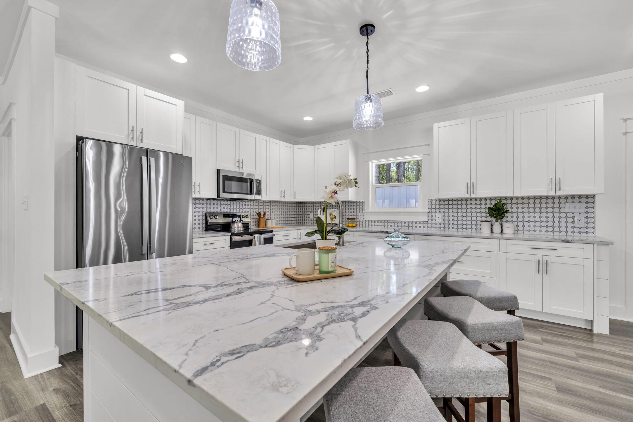 2672 Chat Holley Road Santa Rosa Beach, FL 32459 - Photo 16 of 53 a kitchen with granite countertop stainless steel appliances a sink a stove a center island and chairs