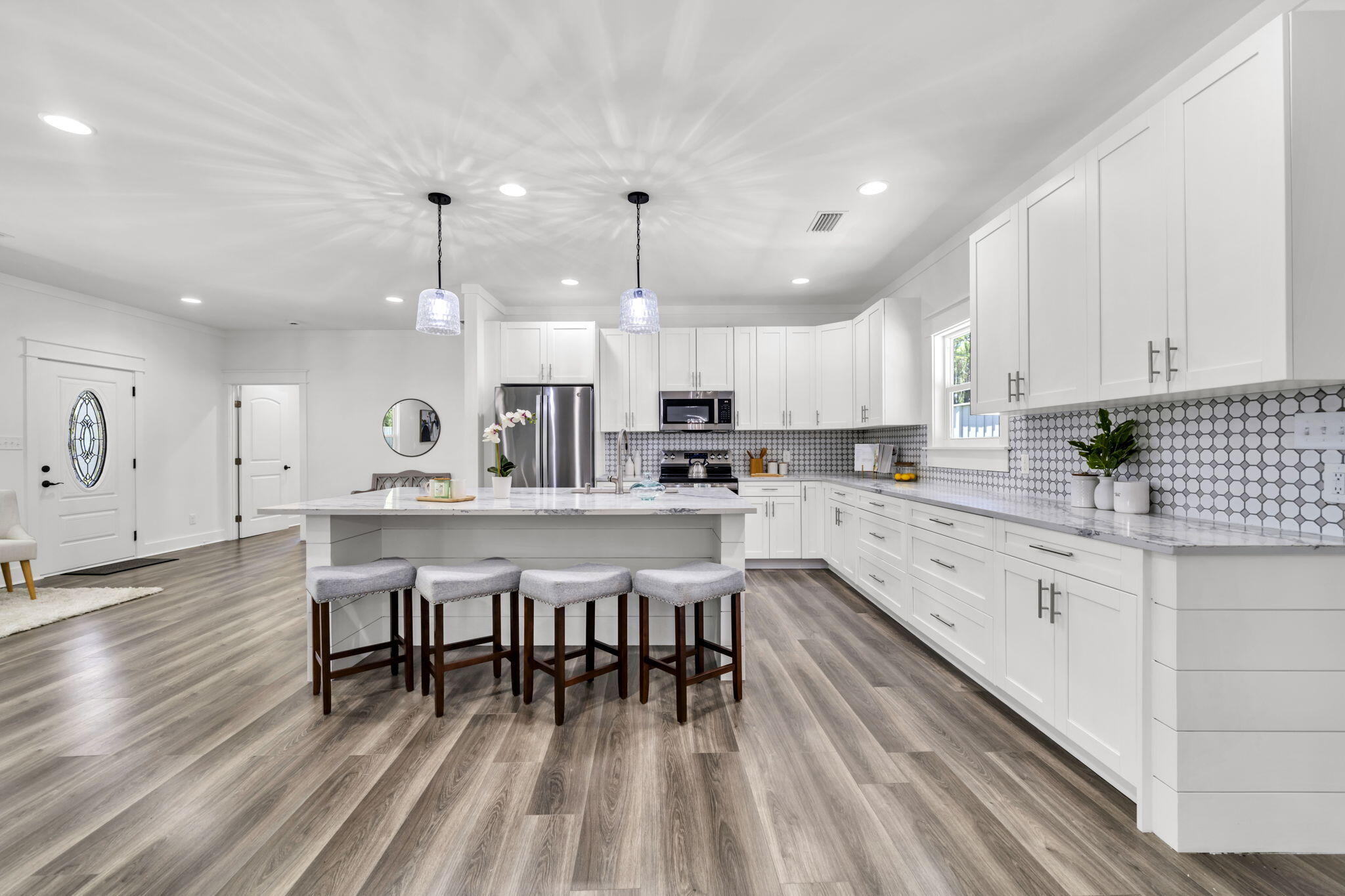 2672 Chat Holley Road Santa Rosa Beach, FL 32459 - Photo 18 of 53 a large white kitchen with lots of counter space dining table and chairs