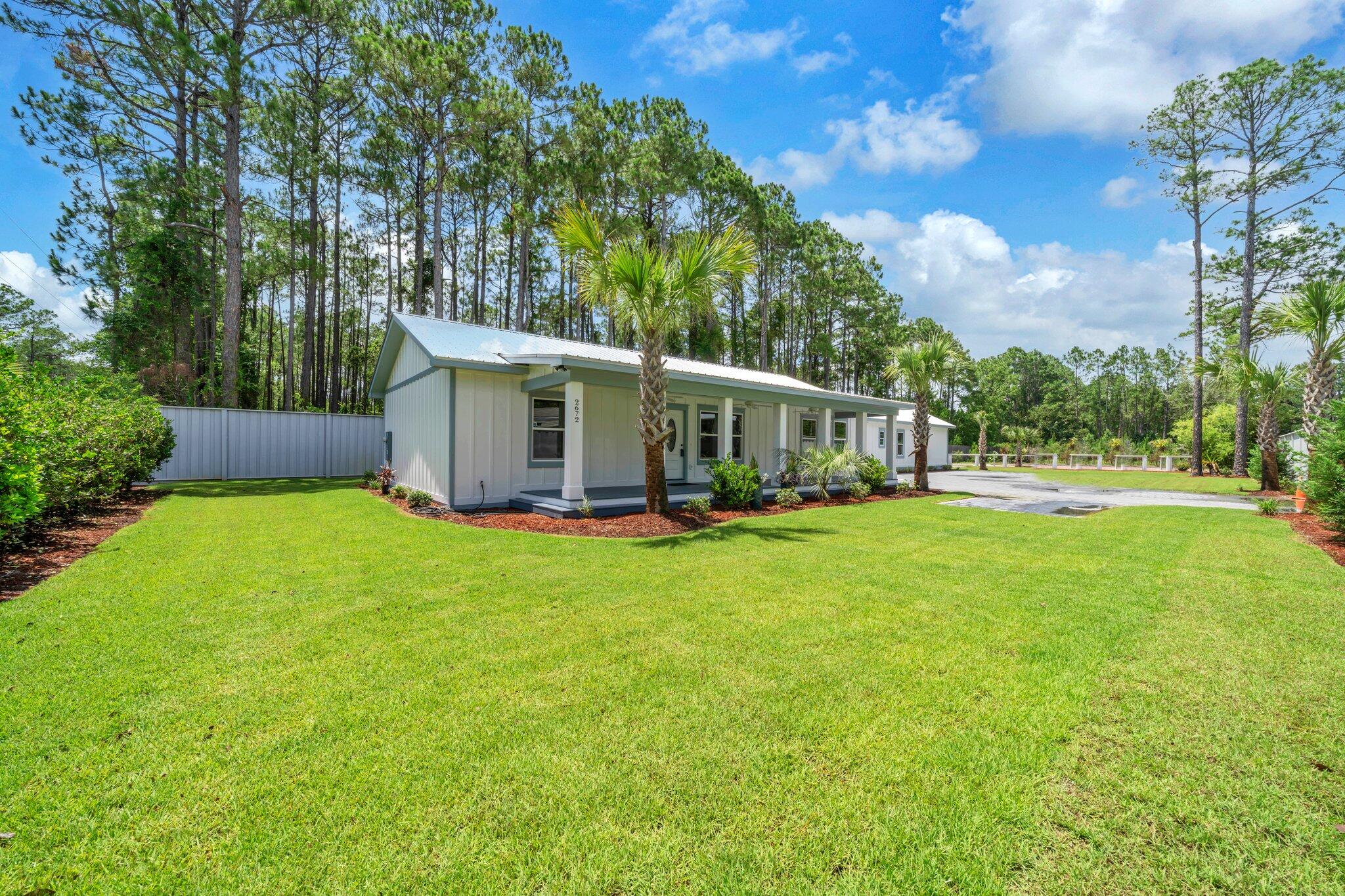 2672 Chat Holley Road Santa Rosa Beach, FL 32459 - Photo 3 of 53 a view of a house with backyard and sitting area