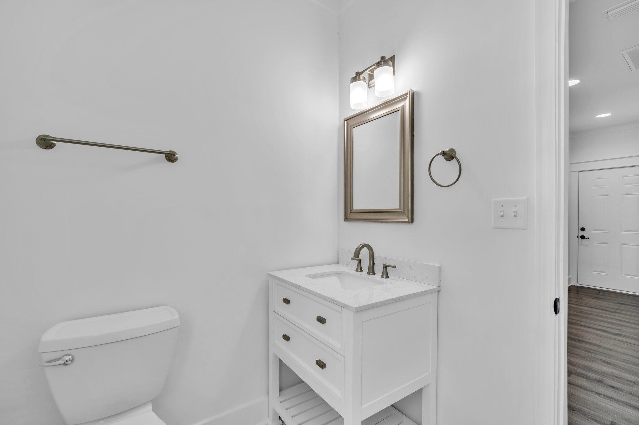 2672 Chat Holley Road Santa Rosa Beach, FL 32459 - Photo 31 of 53 a bathroom with a toilet sink and mirror