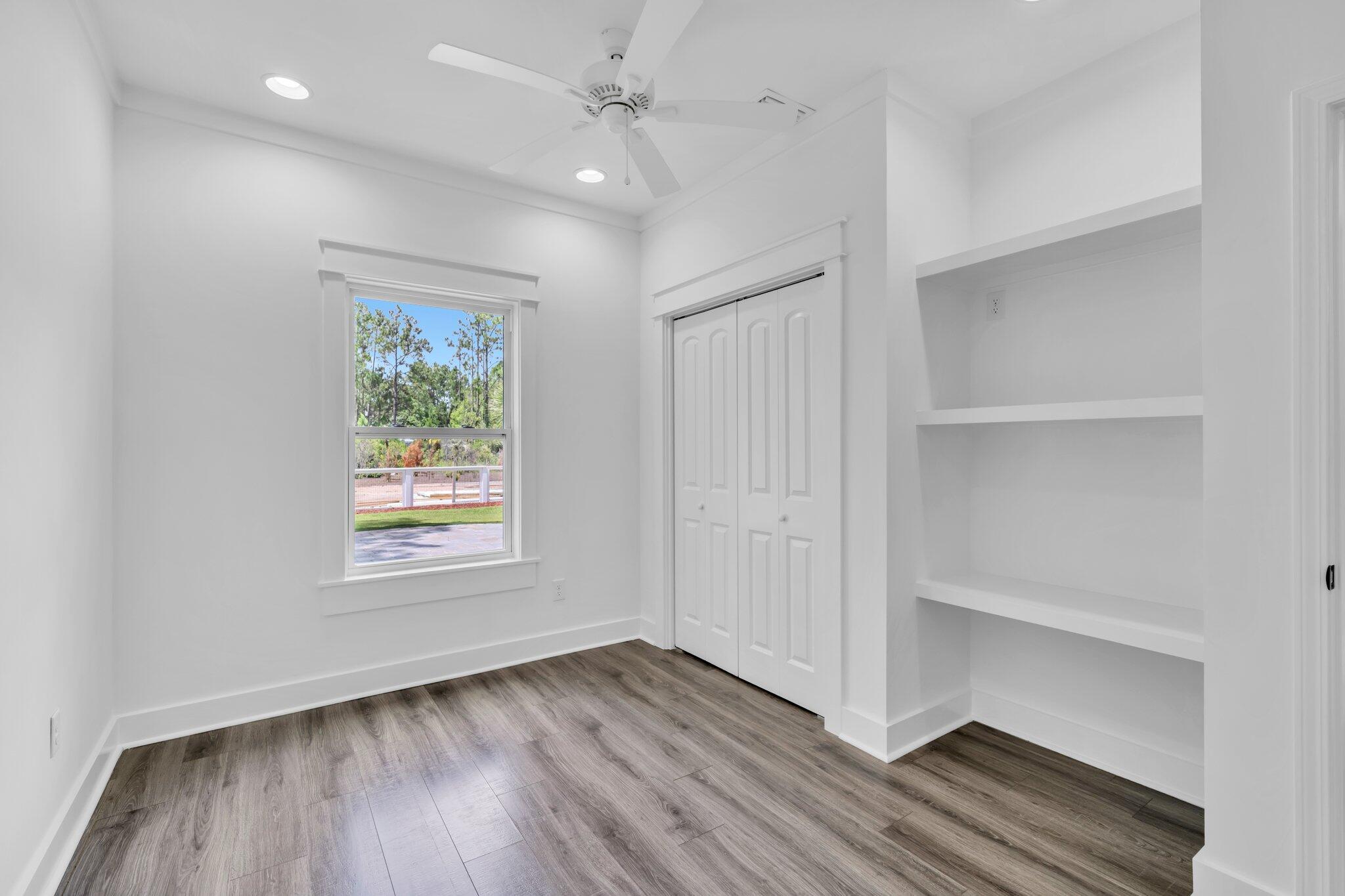 2672 Chat Holley Road Santa Rosa Beach, FL 32459 - Photo 37 of 53 a view of an empty room with a window and wooden floor