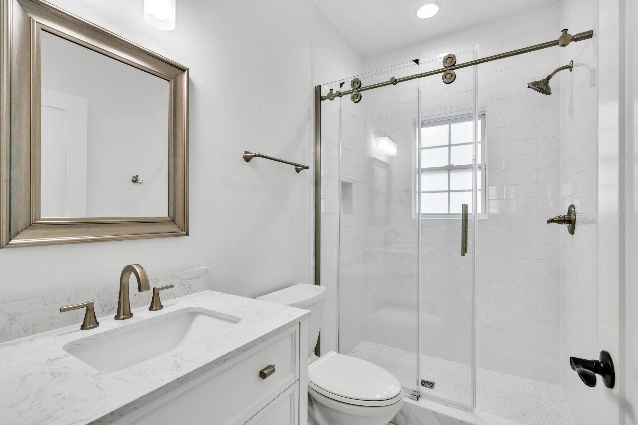 2672 Chat Holley Road Santa Rosa Beach, FL 32459 - Photo 39 of 53 a bathroom with a granite countertop sink toilet mirror and shower